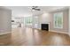 Bright living room with hardwood floors, fireplace, and seamless transition to the modern kitchen at 9220 Yardley Town Dr, Wake Forest, NC 27587