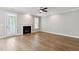 A blank canvas awaits in this open living room with hardwood floors and a cozy fireplace at 9220 Yardley Town Dr, Wake Forest, NC 27587