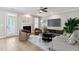 Relax in this stylish living room with plush seating, a fireplace, and a modern ceiling fan at 9220 Yardley Town Dr, Wake Forest, NC 27587
