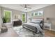 This bedroom features hardwood floors, a ceiling fan, and natural light from the windows at 9220 Yardley Town Dr, Wake Forest, NC 27587
