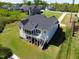 Aerial view of a two-story white house with a dark roof and spacious lawn in a residential area at 9220 Yardley Town Dr, Wake Forest, NC 27587
