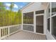 Exterior of a white screened porch with a wooden floor and railings offering private outdoor space at 9220 Yardley Town Dr, Wake Forest, NC 27587