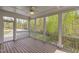 Screened in porch with a ceiling fan, wooden floors and a view of the wooded backyard at 9220 Yardley Town Dr, Wake Forest, NC 27587