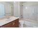 Bathroom featuring a large sink, mirror, and combination shower and tub at 9531 Vira Dr, Raleigh, NC 27617