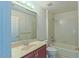 Bathroom featuring single sink vanity, shower over bath tub, and medicine cabinet above the toilet at 9531 Vira Dr, Raleigh, NC 27617