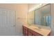 Bathroom with a double sink vanity, large mirror, and a door that leads to the toilet and shower at 9531 Vira Dr, Raleigh, NC 27617