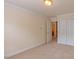 Bedroom with neutral walls, carpeting, window, and baseboard trim; closet with sliding doors at 9531 Vira Dr, Raleigh, NC 27617