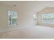 Vaulted bedroom featuring neutral carpet, ample natural light from multiple windows, and a serene atmosphere at 9531 Vira Dr, Raleigh, NC 27617