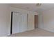 Bedroom with neutral walls, carpeting, window, and baseboard trim; closet with sliding doors at 9531 Vira Dr, Raleigh, NC 27617