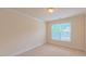 Bedroom with neutral walls, carpeting, window, and baseboard trim; electrical outlets visible at 9531 Vira Dr, Raleigh, NC 27617