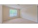 Bedroom with neutral walls, carpeting, window, and baseboard trim; electrical outlets visible at 9531 Vira Dr, Raleigh, NC 27617