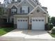 Exterior view of a two-car garage home with brick and siding, showing its symmetrical design at 9531 Vira Dr, Raleigh, NC 27617