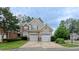 Inviting two-story home with a two-car garage and manicured landscaping at 9531 Vira Dr, Raleigh, NC 27617