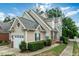 Charming home featuring a one-car garage, brick accents, a manicured lawn, and a traditional design at 9531 Vira Dr, Raleigh, NC 27617