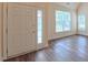 Bright entryway featuring a modern front door and gleaming hardwood floors at 9531 Vira Dr, Raleigh, NC 27617
