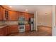 Beautiful kitchen featuring stainless steel appliances, wooden cabinets, hardwood floors, and ample counter space at 9531 Vira Dr, Raleigh, NC 27617