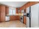 Modern kitchen with stainless steel appliances, wood cabinets, tile backsplash, and ample counter space at 9531 Vira Dr, Raleigh, NC 27617