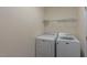 Functional laundry room featuring modern washer and dryer units at 9531 Vira Dr, Raleigh, NC 27617