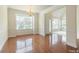 Elegant living room showcasing gleaming hardwood floors, and abundant natural light from large windows at 9531 Vira Dr, Raleigh, NC 27617