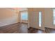 Open living area showcasing hardwood floors, modern lighting, and large windows at 9531 Vira Dr, Raleigh, NC 27617