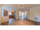Open-concept living area with hardwood floors, leading to a kitchen, staircase, and a dining area at 9531 Vira Dr, Raleigh, NC 27617