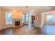 Spacious living room boasting a cozy fireplace, hardwood floors, and large windows offering ample natural light at 9531 Vira Dr, Raleigh, NC 27617