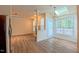 Open-concept living space with hardwood floors, seamlessly connecting to a kitchen, fireplace, and deck access at 9531 Vira Dr, Raleigh, NC 27617