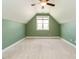 Upstairs attic area featuring carpet floors, a window for natural light, and neutral paint at 96 Ada Cir, Selma, NC 27576