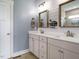 Bathroom with double vanity, framed mirrors, and modern lighting fixtures at 96 Ada Cir, Selma, NC 27576