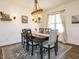 Farmhouse dining room features rustic chandelier, neutral decor, and a large window with views to the outside at 96 Ada Cir, Selma, NC 27576