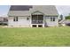 Back exterior featuring a well-manicured lawn, and solar panels at 96 Ada Cir, Selma, NC 27576