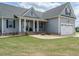 Inviting home with a manicured lawn and a stone-accented front porch, plus attached two car garage at 96 Ada Cir, Selma, NC 27576