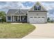 Charming two-story home with a well-manicured lawn, attached two car garage and covered front porch at 96 Ada Cir, Selma, NC 27576