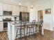 Modern kitchen with granite counters, stainless appliances, island with bar stool seating and hardwood flooring at 96 Ada Cir, Selma, NC 27576