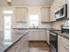 Bright kitchen features light countertops, stainless steel appliances, ample cabinet space, and modern fixtures at 96 Ada Cir, Selma, NC 27576