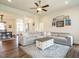 Bright, open living room features a large sectional sofa, ceiling fan, and modern decor at 96 Ada Cir, Selma, NC 27576