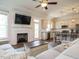 Inviting living room with fireplace, mounted TV, and open layout to a modern kitchen at 96 Ada Cir, Selma, NC 27576