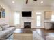 Relaxing living room featuring a fireplace with large-screen TV and access to the backyard at 96 Ada Cir, Selma, NC 27576