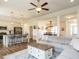 An open-concept living room seamlessly connects to the kitchen, featuring a ceiling fan at 96 Ada Cir, Selma, NC 27576