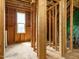 Unfinished room featuring wood studs, a window, and wood flooring at 96 Ada Cir, Selma, NC 27576
