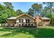 Well-manicured backyard with a wooden deck, complemented by lush greenery and a serene atmosphere at 1005 Greenwood Cir, Cary, NC 27511