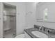 Cozy bathroom featuring a step-in glass shower and a modern vanity with granite countertop at 1005 Greenwood Cir, Cary, NC 27511