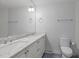 Well-lit bathroom with double sinks and marble countertops, offering a clean and modern design at 1005 Greenwood Cir, Cary, NC 27511