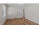 Bright bedroom featuring hardwood floors, a ceiling fan, and closet space at 1005 Greenwood Cir, Cary, NC 27511
