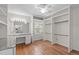 Spacious bedroom featuring custom closet organization, a vanity area, and hardwood floors at 1005 Greenwood Cir, Cary, NC 27511