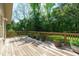 Inviting wooden deck bordered by lush greenery and potted plants, perfect for outdoor relaxation at 1005 Greenwood Cir, Cary, NC 27511