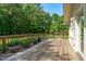 Scenic view of the wooden deck with potted plants and lush green surroundings at 1005 Greenwood Cir, Cary, NC 27511