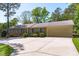 Spacious ranch home featuring an attached garage and long driveway surrounded by greenery at 1005 Greenwood Cir, Cary, NC 27511