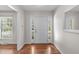 Inviting foyer features hardwood floors, white walls, and a window for natural light at 1005 Greenwood Cir, Cary, NC 27511