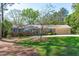 Charming one-story brick home with blue shutters, lush lawn, and mature flowering tree at 1005 Greenwood Cir, Cary, NC 27511